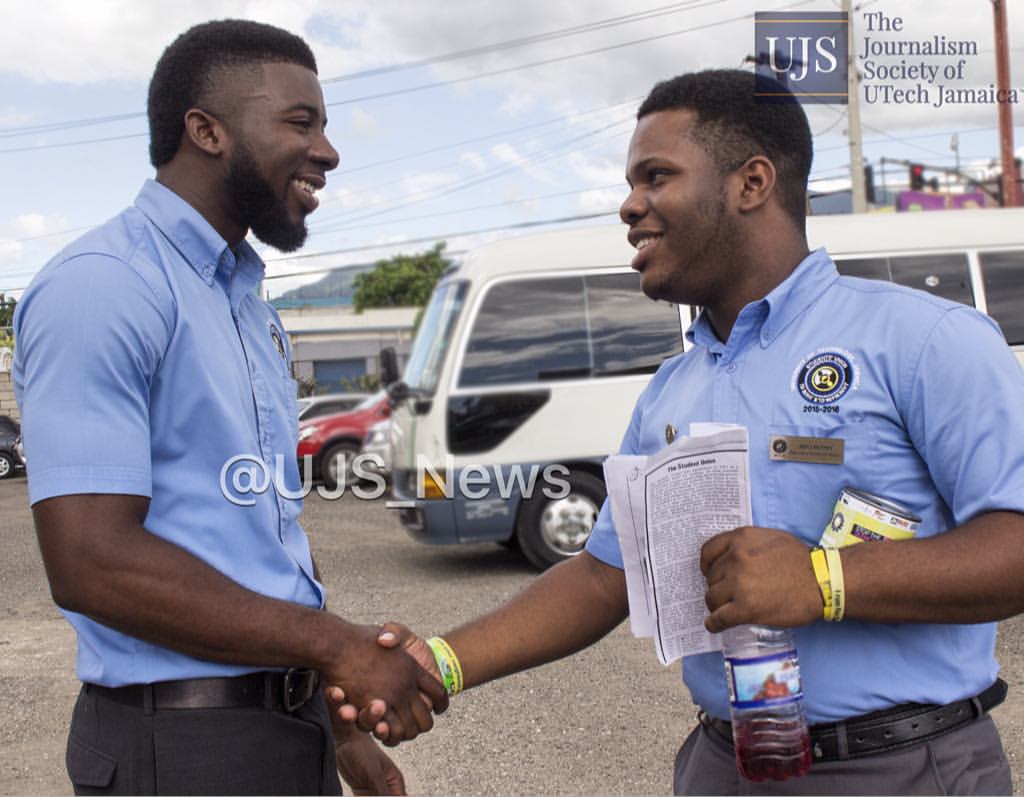 Darrian McGhann (left),President of the Students' Union congratulates his colleague Akili Henney (right) Director of Community Services on a successful opening service for the week of activities. Tag drive 2015 "stop the silence... end the violence".