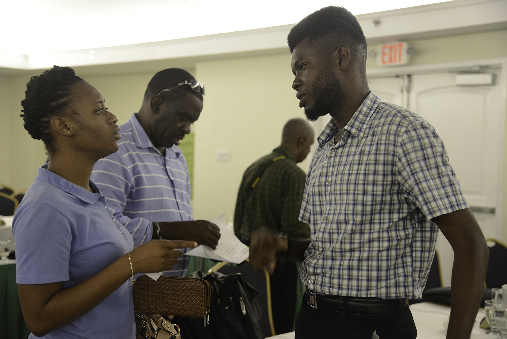 Crystal Taylor, University of Technology student having discussion with Chevy Devonish, Law Student from the University of Guyana.