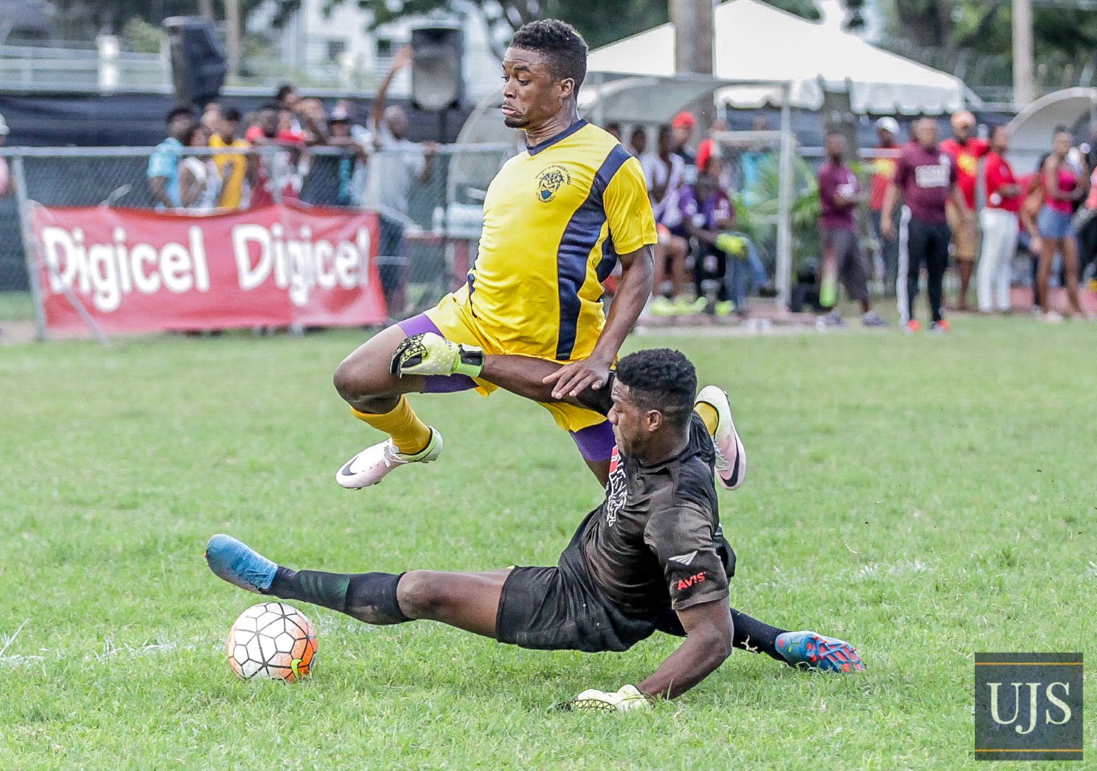 University of Technology, Ja forward player Dorvil Jackson skips away from UWI Mona custodian in an enticing football encounter at the UWI/UTech Games