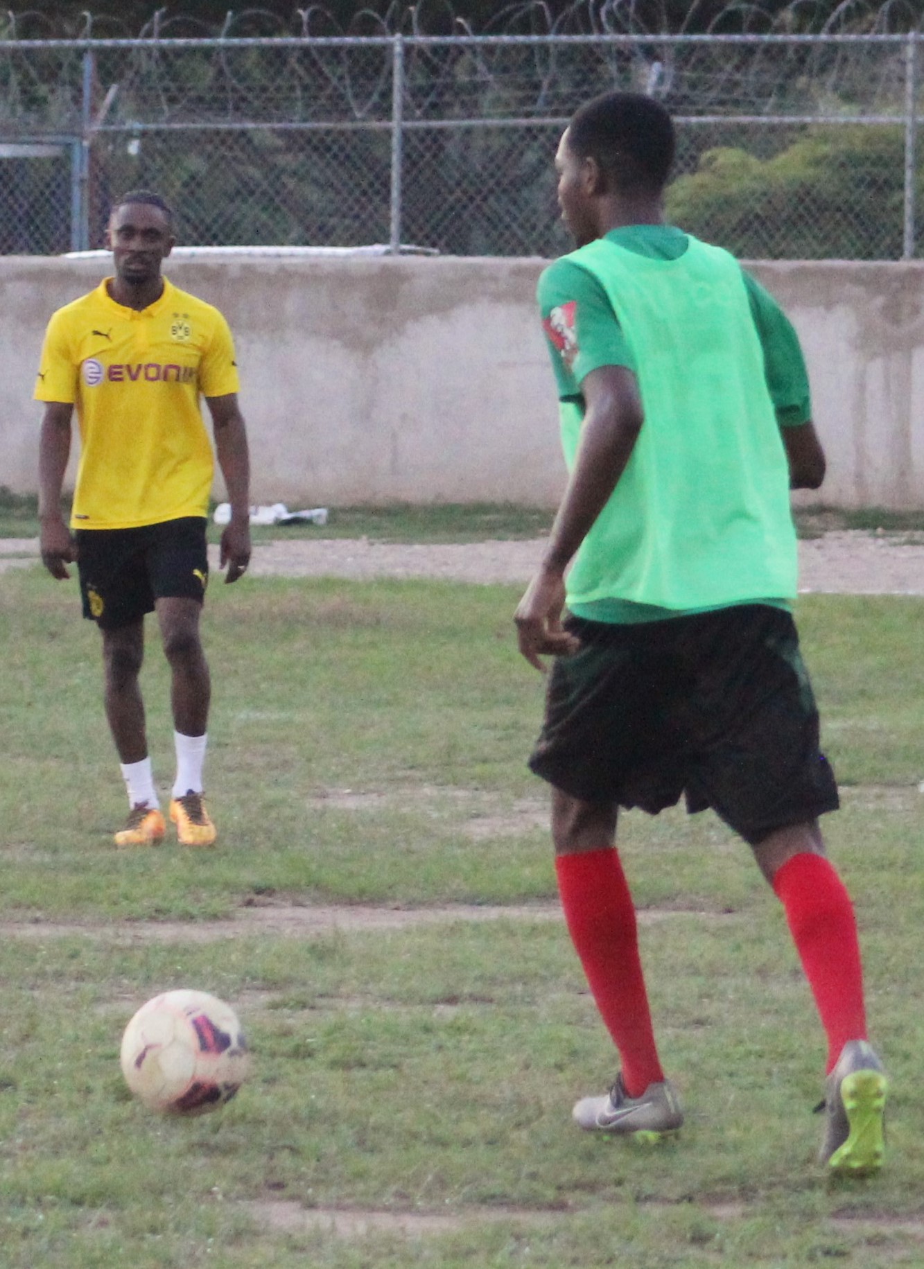 Paul Newman in control of the ball for UTech, Jamaica facing a tired looking Christopher Martin of the Celebrities team during their practice match against UTech, Jamaica on October 7 2016.