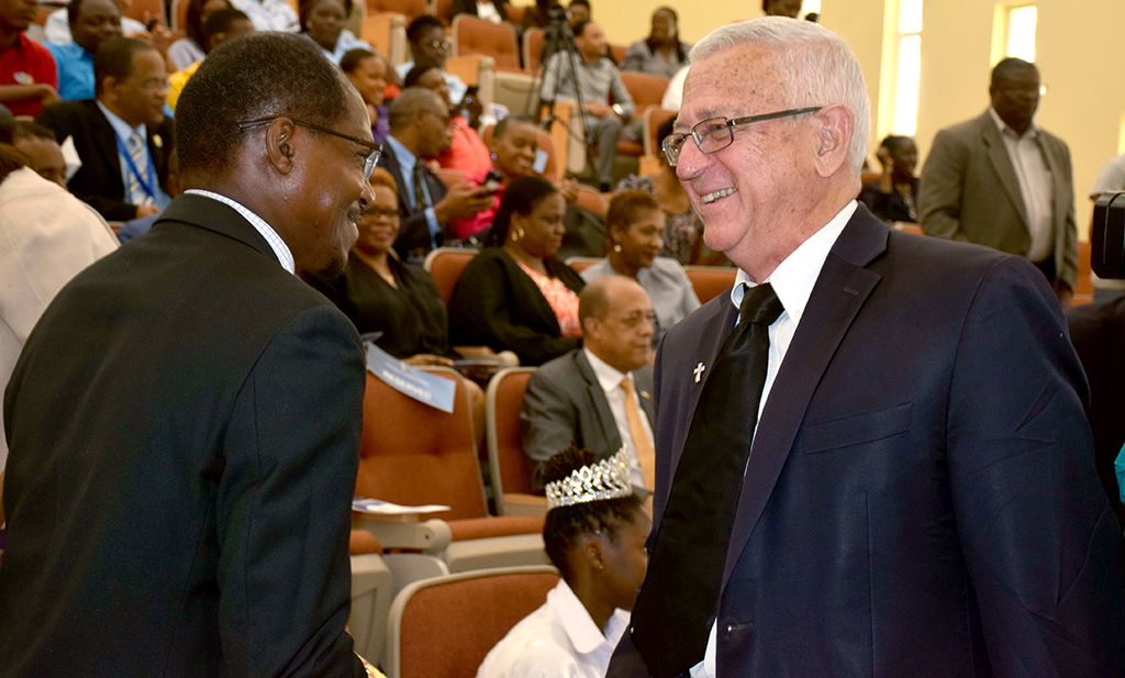 Professor Collin Gyles, Deputy President, University of Technology, Jamaica engaged Honorable Reverend Ronald Thwaites (right) with a handshake during the ceremony of the University of Technology, Jamaica 60th anniversary launch, March 20, 2018. Photograph by UJS News/Chenea Taffe