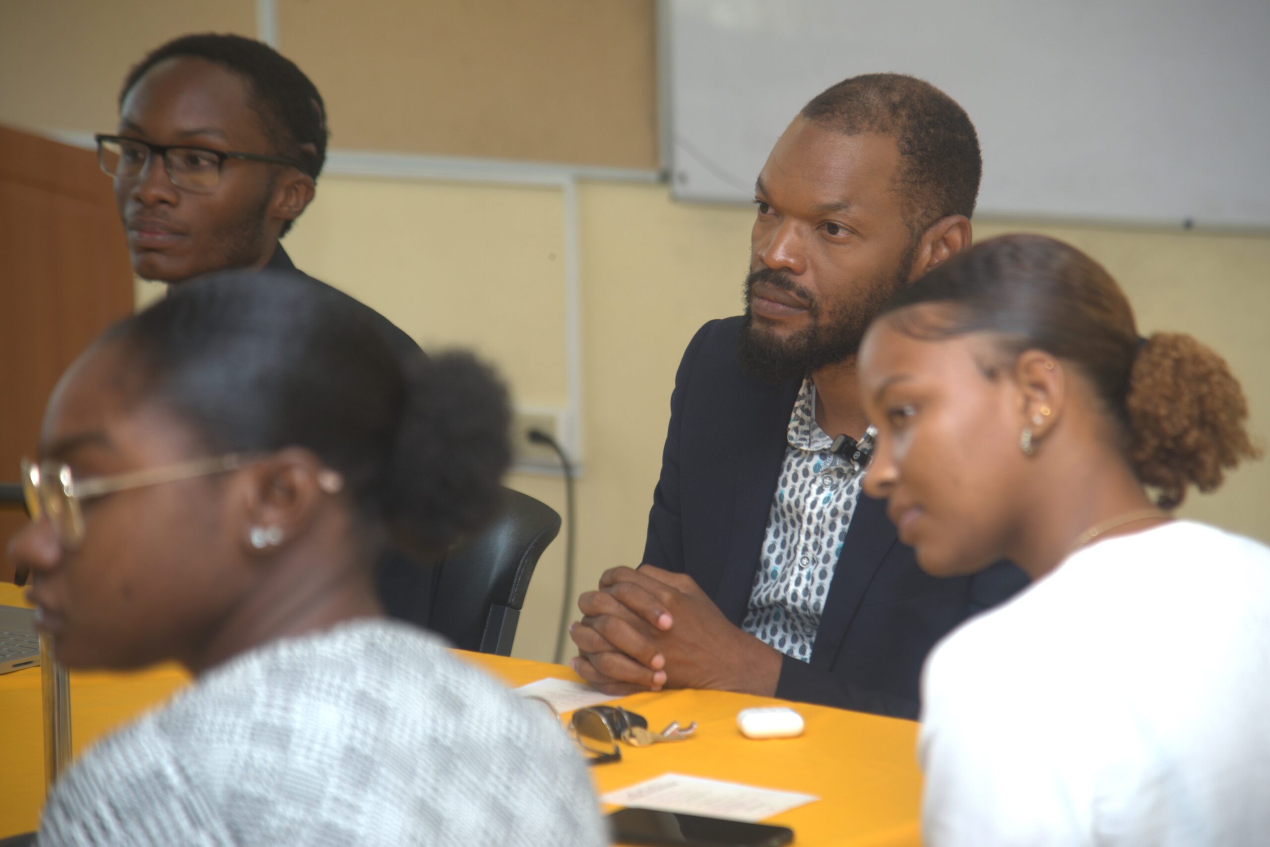 Raymond Pryce (centre) listens intently to a student's question during a panel discussion at the University of Technology, Jamaica on March 14, 2024. Also present are moderator Aaron Brown (left), and panellists (from left) Rohanna Forrester and Amanda Fong-Tom.